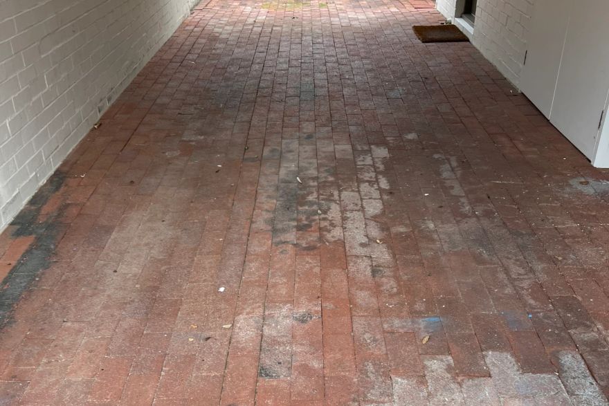 Before and after cleaning on brick pavers · Garage floor: before