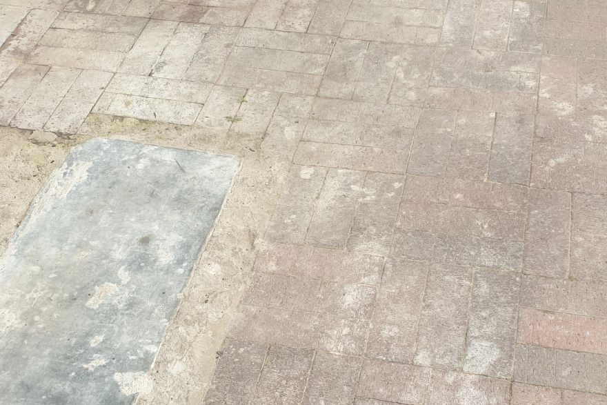 Before and after cleaning on brick pavers: before