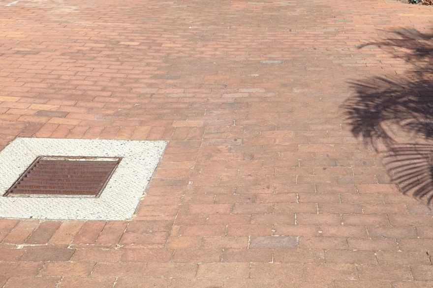 Before and after cleaning on brick pavers: before