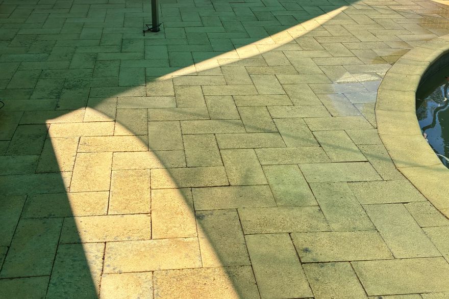 Before and after cleaning on brick pavers · Poolside: after