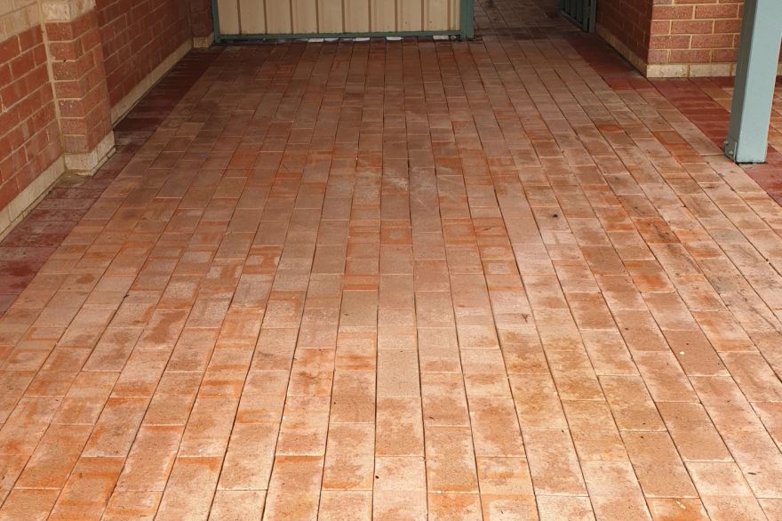 Before and after cleaning on brick pavers · Driveway: after