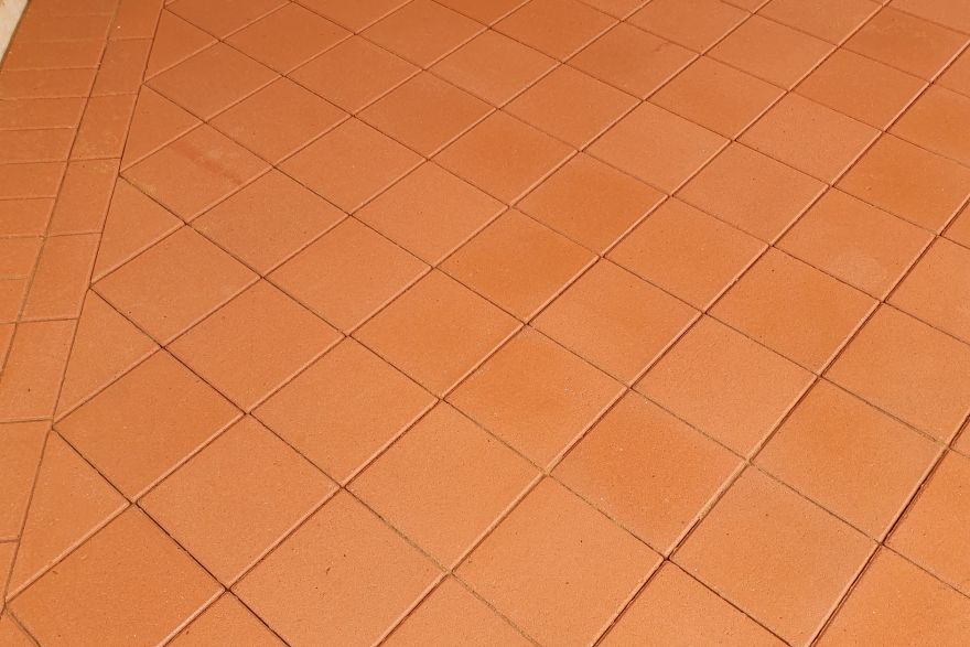Before and after paint removal on brick pavers · Patio / alfresco: after