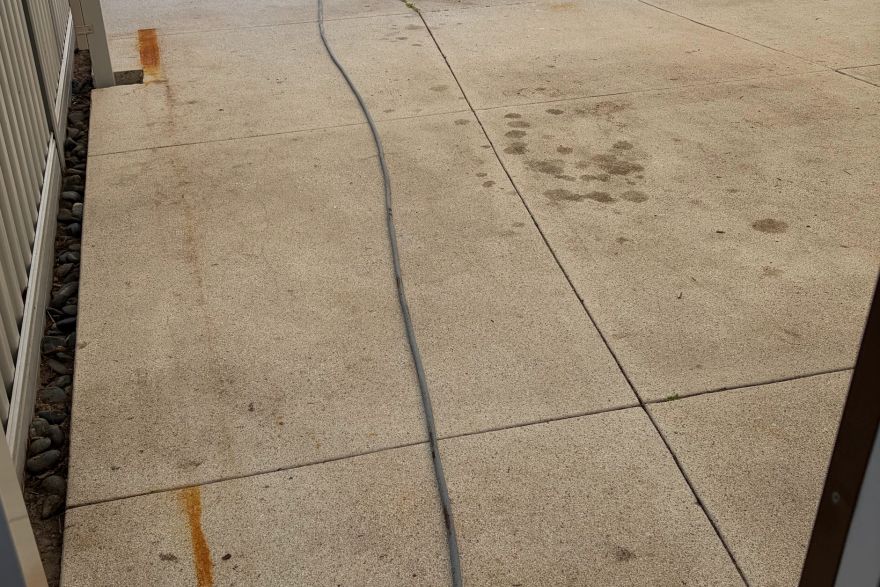 Before and after rust / bore stains on concrete exposed aggregate: before