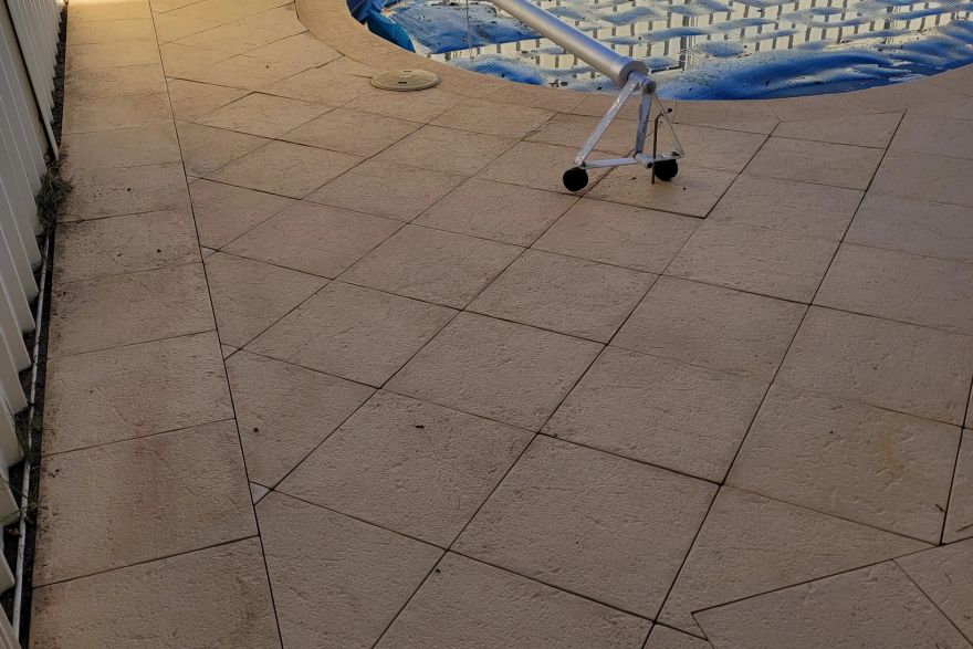 Before and after cleaning on sandstone pavers · Poolside: after