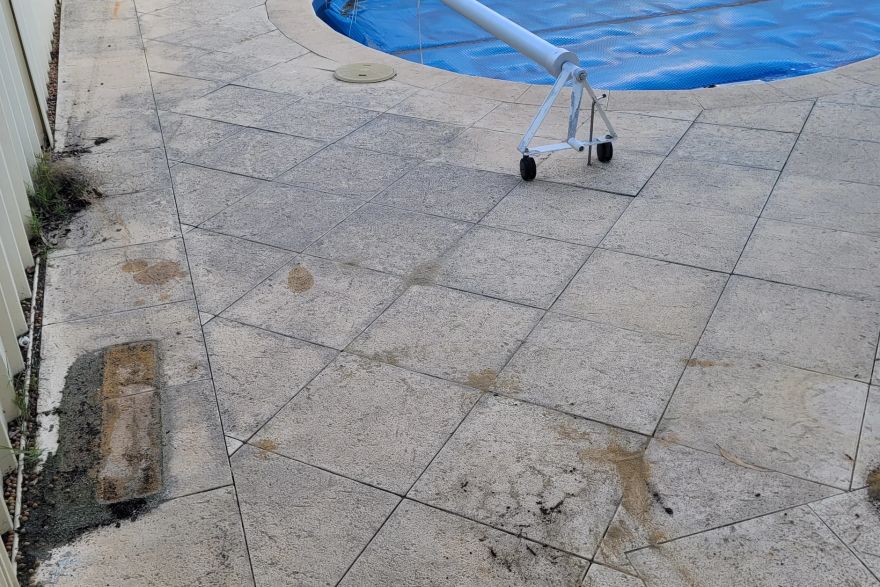Before and after cleaning on sandstone pavers · Poolside: before