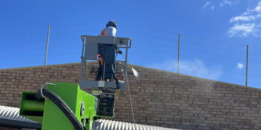 Job 136 high-wall graffiti removal: Michael working from a cherry picker.