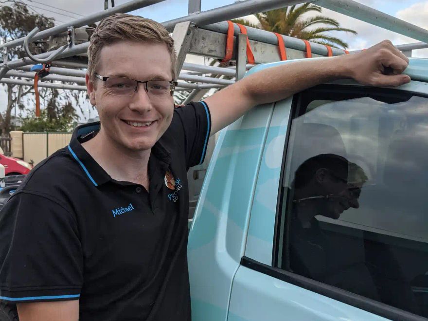 Michael from ProWash Squirrels beside his work van